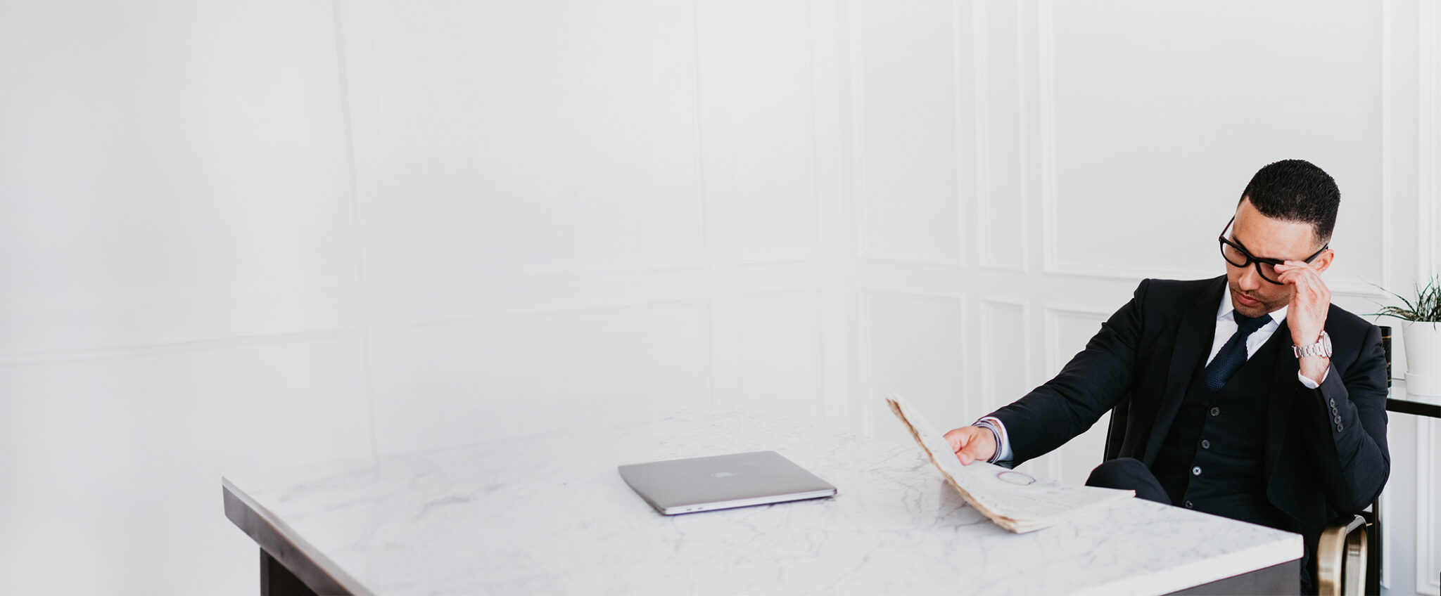 Kamran Zand reading at his office desk